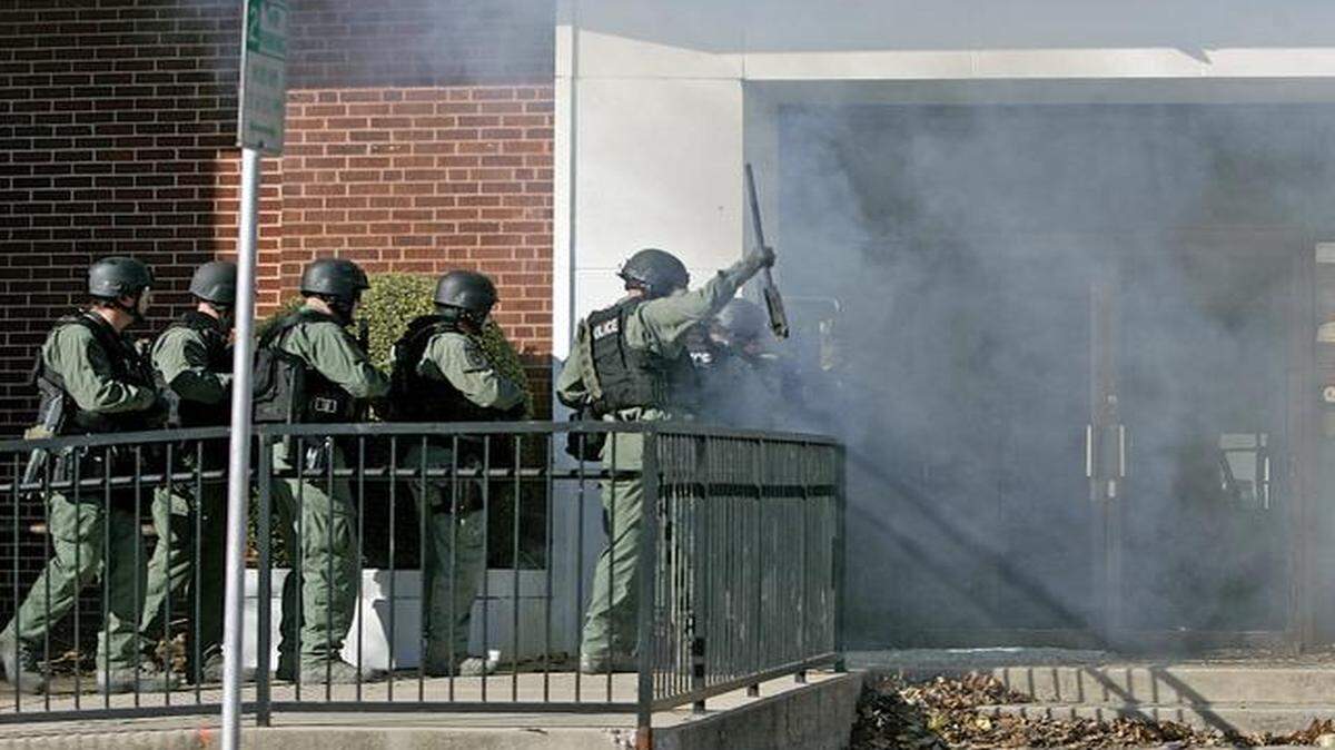 
After setting off an explosive, Fort Worth SWAT officers enter a door at the empty Fort Worth Police Association building Monday, Feb. 9, 2015. 
