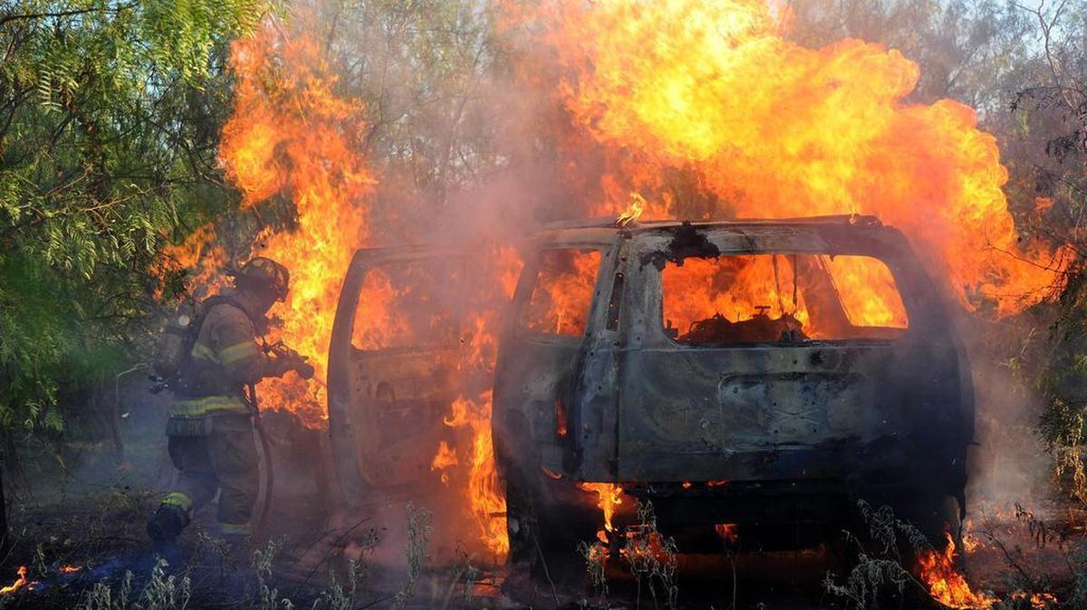 Fort Worth firefighters extinguish a vehicle fire in the 5700 block of Wilbarger Street (east of Loop 820) around 6 p.m. Tuesday. The vehicle was about 100 feet off the road. After extinguishing the fire, firefighters found at least one body in vehicle and called the police.