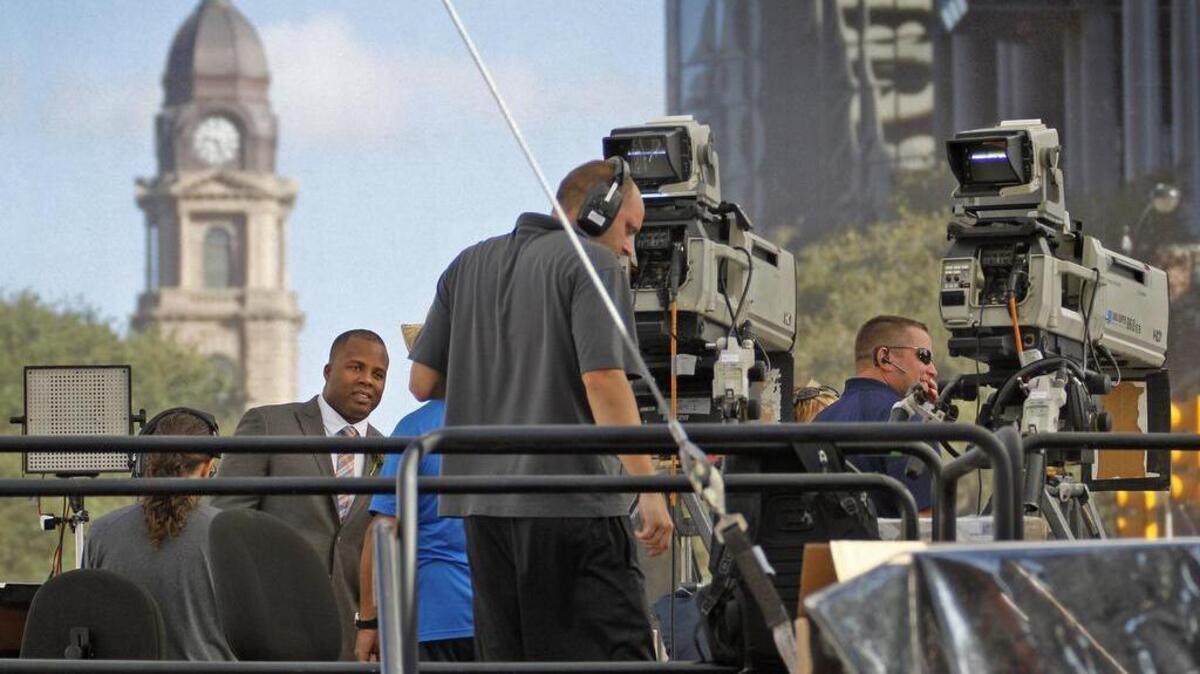 
ESPN's George Whitfield talks with his stage crew before going on-air in Sundance Square Plaza Friday morning.
