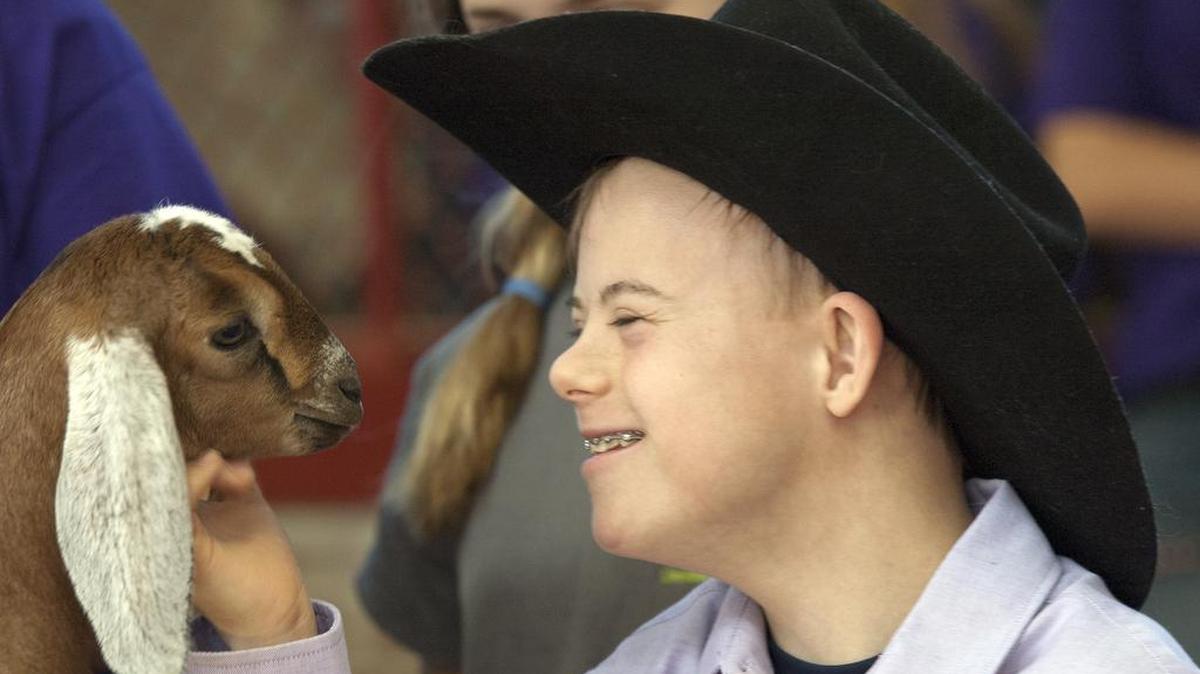Wyatt Kwentus pets a baby goat as he and other special needs students attend a livestock class to give them experience in showing animals at the Tarrant County Junior Livestock Show Saturday.