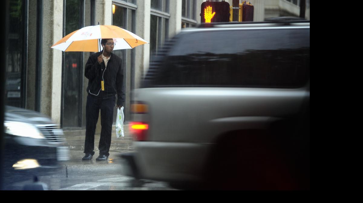 
A pedestrian takes cover under an umbrella during a recent lunchtime rain in downtown Fort Worth. Forecasters are calling for heavy rainfall in parts of North Texas on Tuesday and Wednesday.

