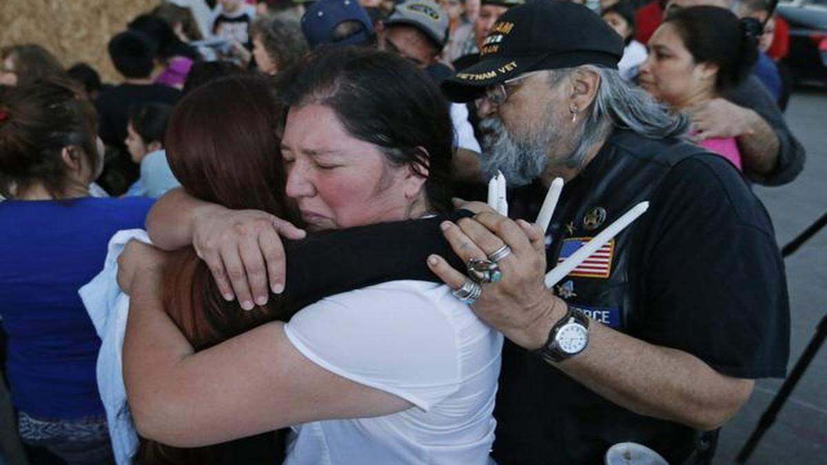 
Laticia Galdiano, center, is consoled at a vigil Wednesday, April 1, 2015, in memory of her daughter Sylvia Zazueta, who was killed Tuesday when a driver lost control of his vehicle at the corner of East Lancaster Avenue and Riverside Drive and crashed into a convenience store. 
