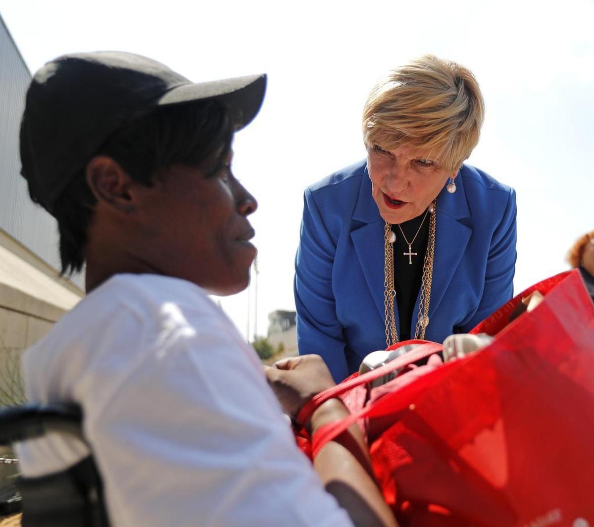 Fort Worth Mayor Betsy Price talks with Shaquisha Hunter before Hunter boards the bus back to Port Arthur at Wilkerson-Greines Activity Center in Fort Worth Monday.