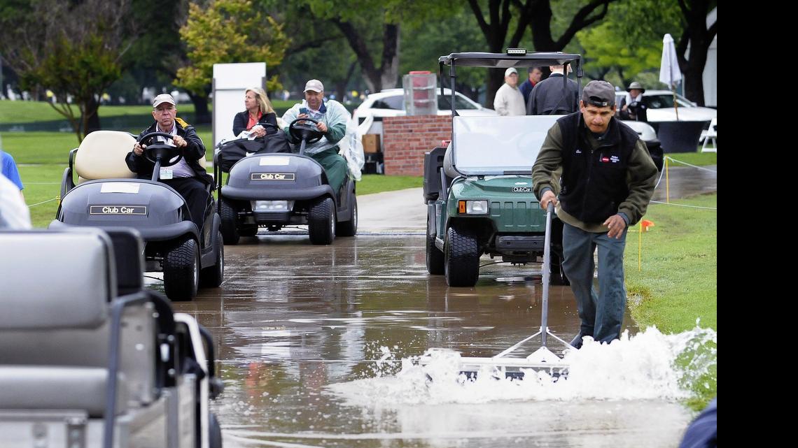 
Crews remove standing water near the first hole during a rain delay at the Crowne Plaza Invitational at Colonial Country Club in Fort Worth on Thursday.
