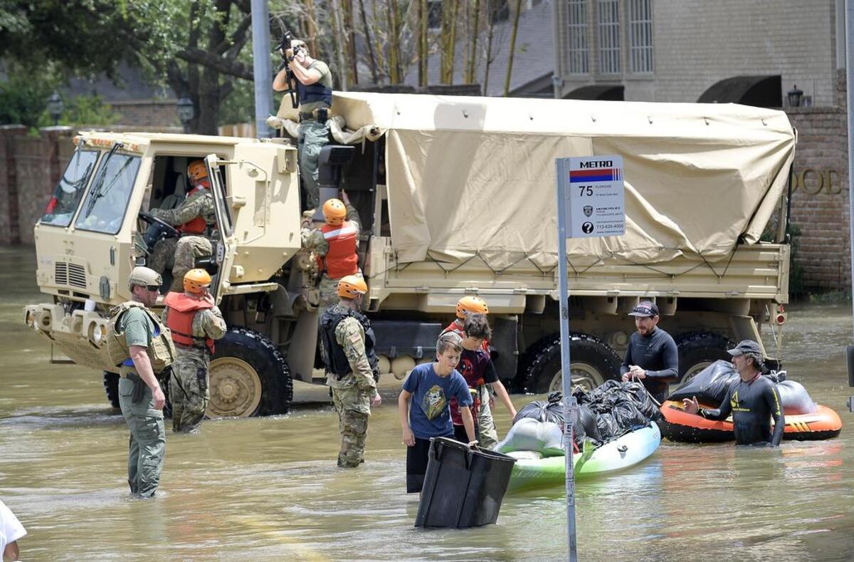 Grand Prairie police teamed up with members of the Texas Army National Guard to assist residents in west Houston, who were using kayaks and canoes to bring personal items out of their homes.