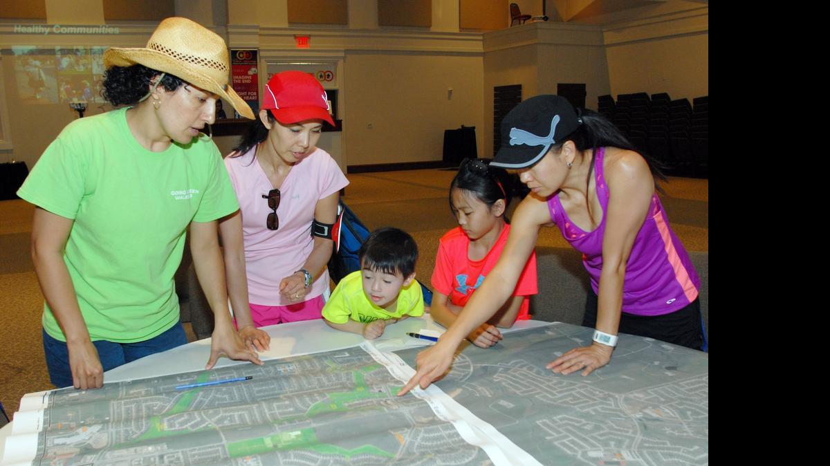 
Alicia Ortiz, left along with Susan McLoud, son William McLoud, Ariannna Thayravanh and Litchana Thayravanh look over maps of their neighborhood as they participate in a Blue Zones Project workshop at the Heritage Church of Christ north of Fort Worth. The purpose of the workshop was to get input on potential changes to improve walkability in the area.
