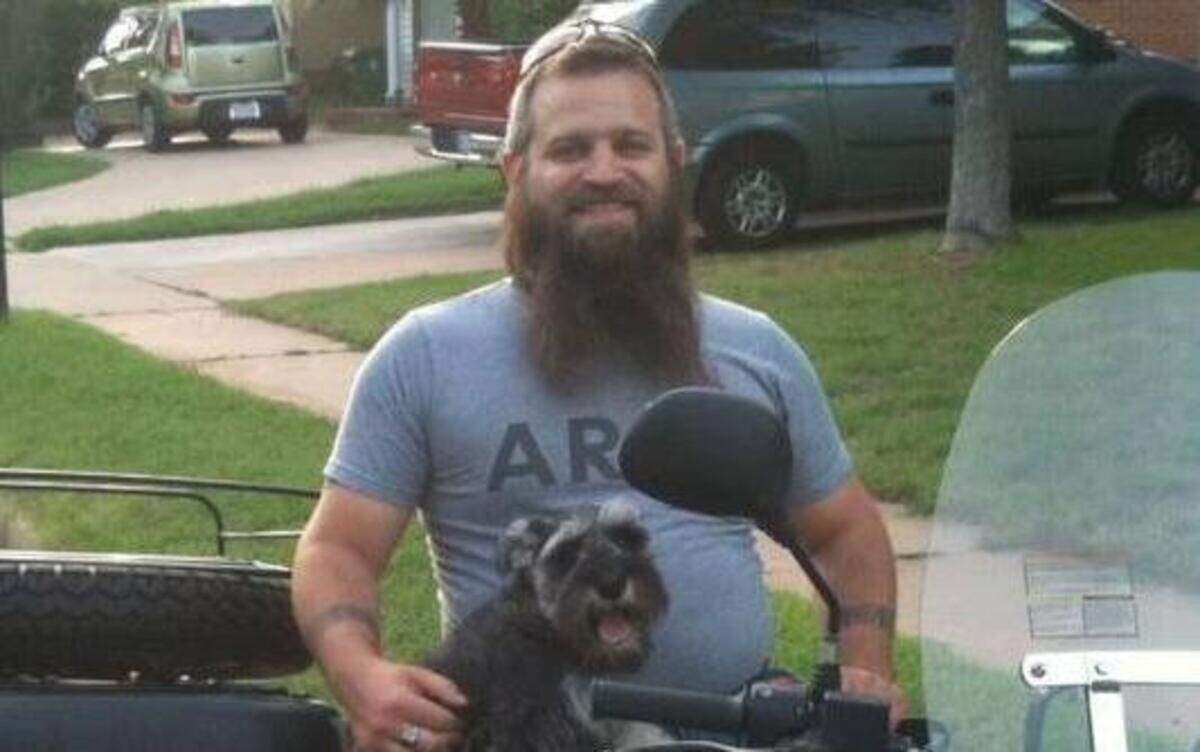 
Eric Peterson, 32, with his dog, Trigger. Peterson was fatally shot Saturday night while working at the Military Gun Supply store at 2901 S. Cravens Road. 

