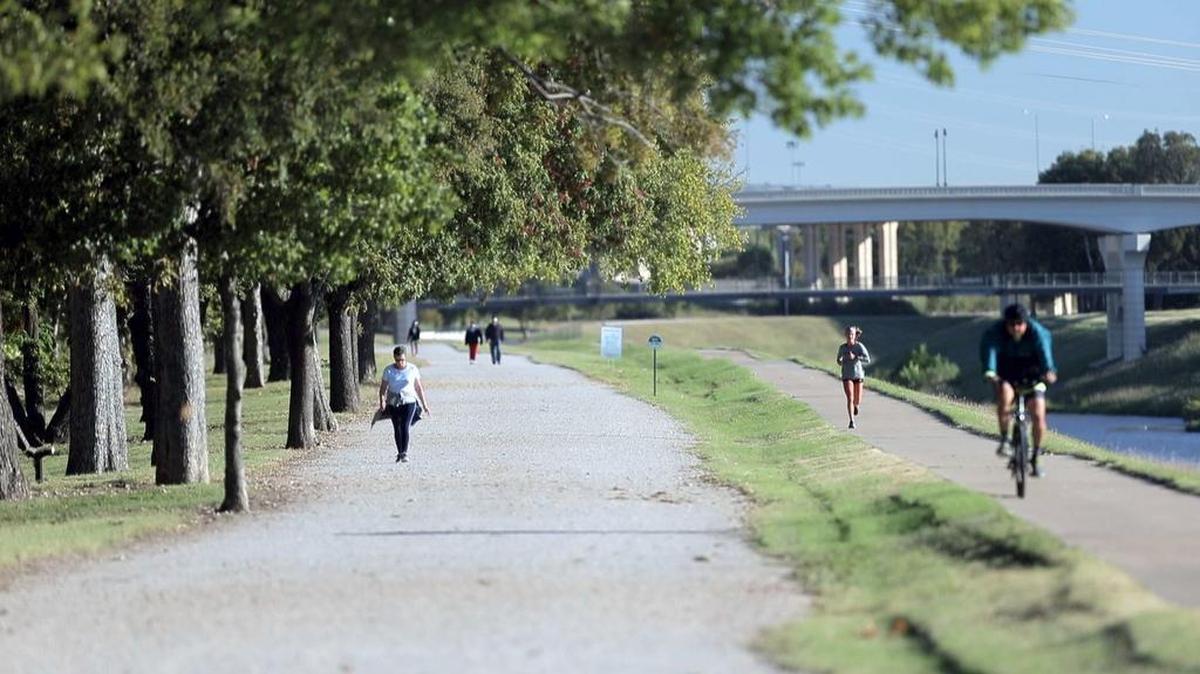 Walkers, runners and cyclist use the Trinity Trail near the Clear Fork development in Fort Worth last month. Plans are afoot to expand the trail system to more than 200 miles.