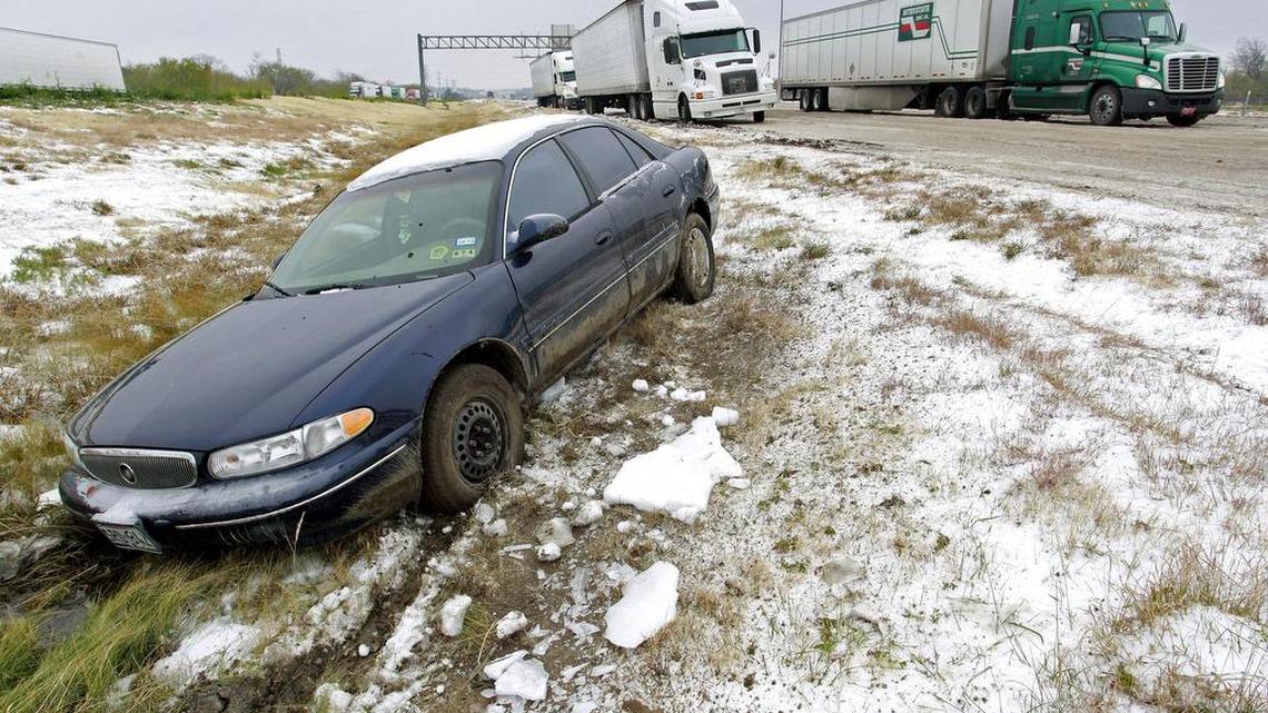 An ice storm in December 2013 paralyzed much of North Texas. Here, a car that slid off of the road sits abandoned on I-20 in Benbrook.