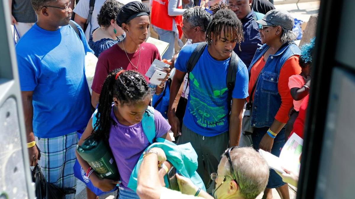 Hurricane Harvey evacuees board a bus at the Wilkerson Greines Activity Center in Fort Worth Sept. 18 that took them back to their homes.