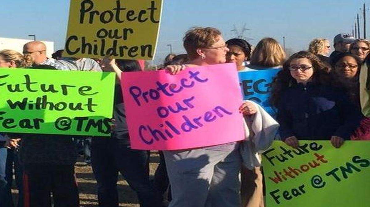 
Of the more than 1,000 students that attend John Tidwell Middle School, about 170 were absent March 23 after the return of a student accused of writing a violent and sexual story that targeted classmates. Parents and students protested the blog’s contents outside of John Tidwell Middle School on March 23
