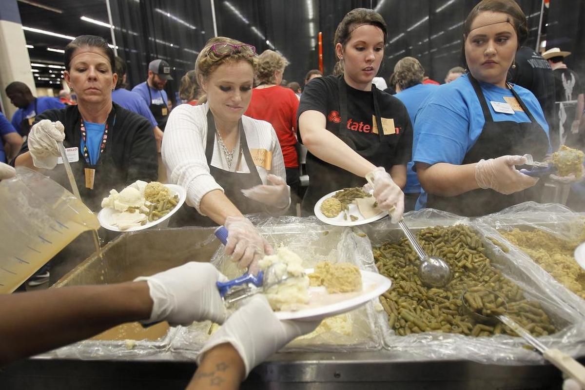 Volunteers Jennifer Lewis, left, Tanya Griebe, Amanda Bray and Sage Bevan prepare food during the H-E-B/Central Market Feast of Sharing at Will Rogers Memorial Center in Fort Worth on Tuesday, Nov. 10, 2015.