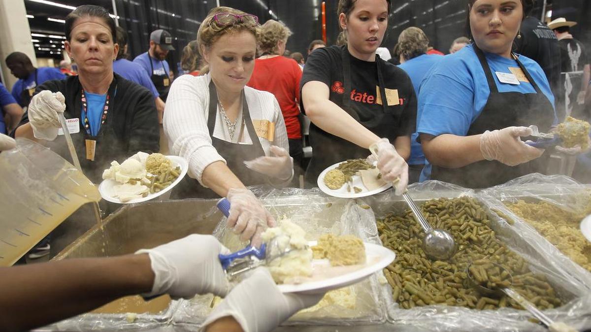 Volunteers Jennifer Lewis, left, Tanya Griebe, Amanda Bray and Sage Bevan prepare food during the H-E-B/Central Market Feast of Sharing at Will Rogers Memorial Center in Fort Worth on Tuesday, Nov. 10, 2015.