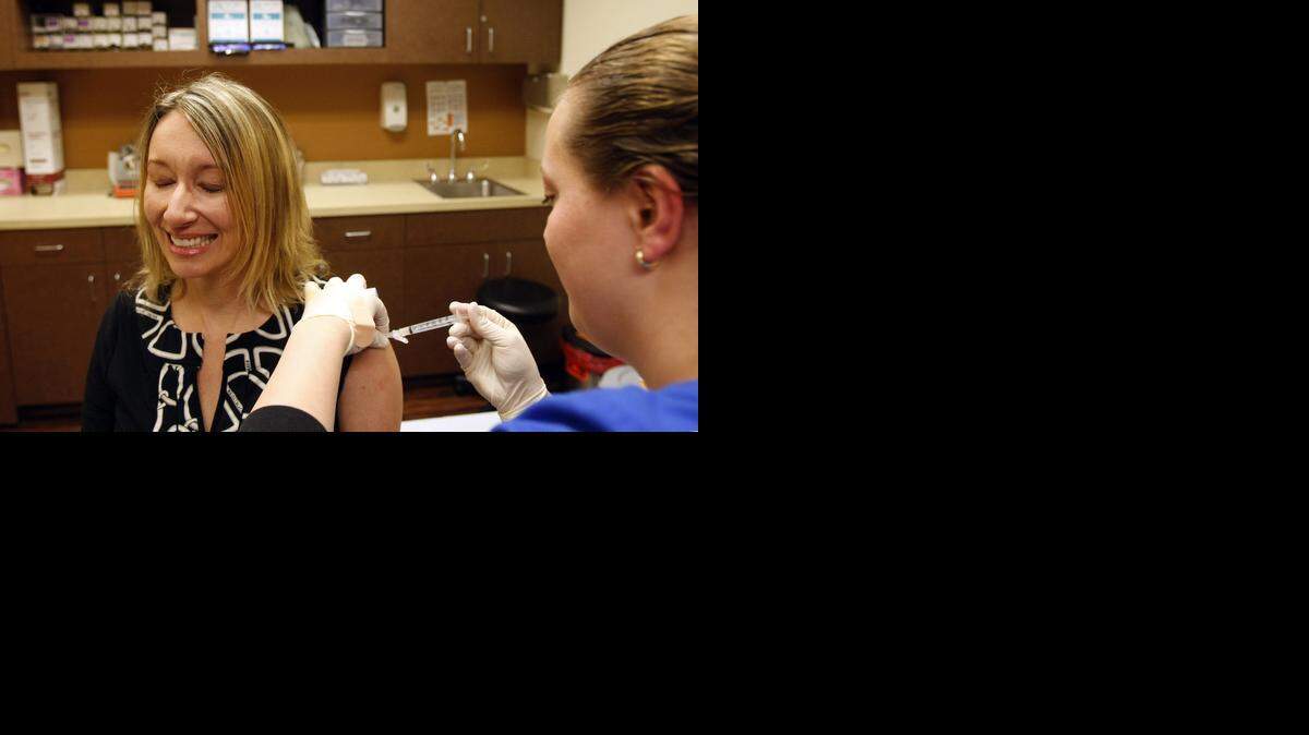 
Cheri Mann gets a flu shot at CareNow in north Fort Worth on Wednesday. Tarrant County is seeing flu cases on the upswing and the season is running about three weeks ahead of last year.
