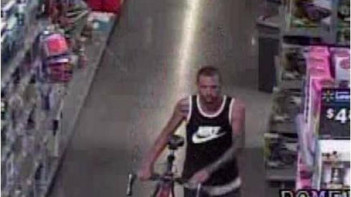 A surveillance photo from the Walmart at 2245 Jacksboro Highway on June 20 shows the armed robber with the bicycle he stole.