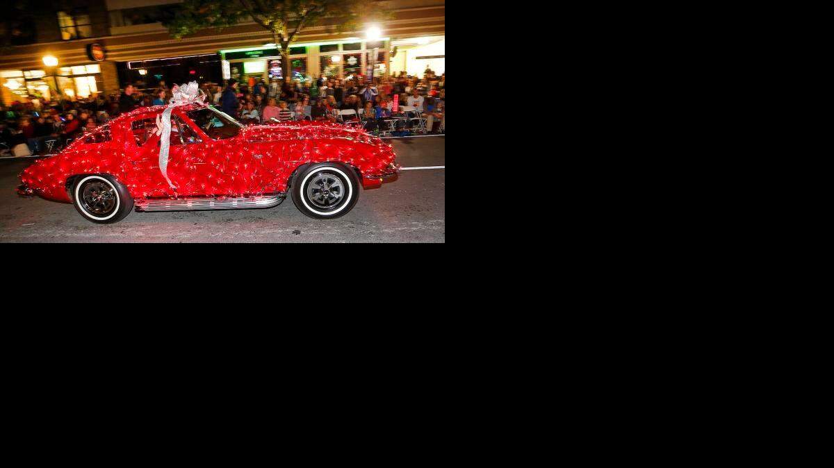 
A decorated vintage Corvette drives past parade goers in the 2014 XTO Energy Parade of Lights in downtown Fort Worth.
