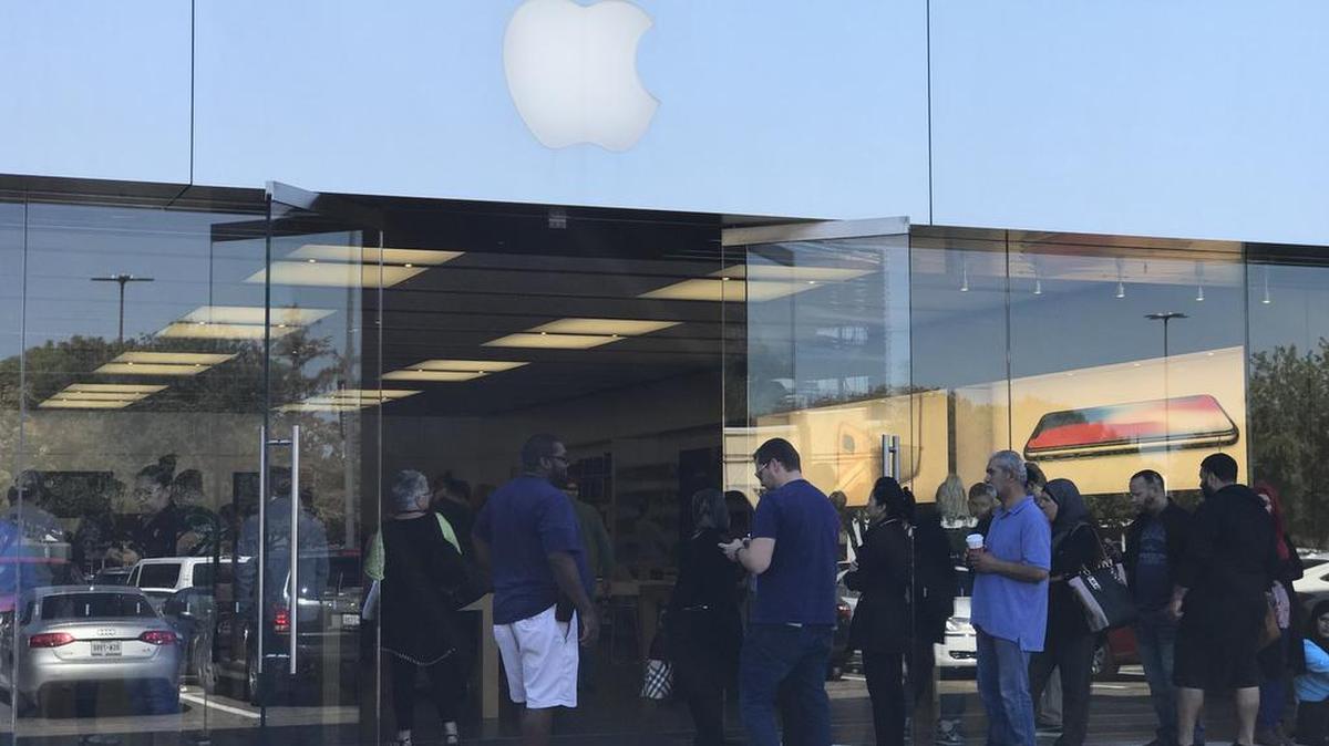 Customers line up Tuesday morning to get into the Apple Store at University Park Village in Fort Worth.