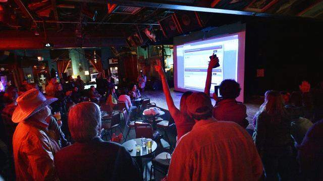 
The crowd reacts as the unofficial results from early voting were shown in Denton at a nonpartisan election watch party for the proposed ban on hydraulic fracturing. 
