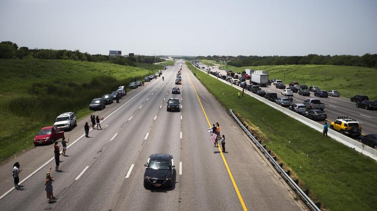A procession for slain Dallas police officer Patrick Zamarripa travels on Interstate 20 to the Dallas-Fort Worth National Cemetery on July 16, 2016, in Grand Prairie, Texas. (Special to the Star-Telegram/Andrew Buckley)