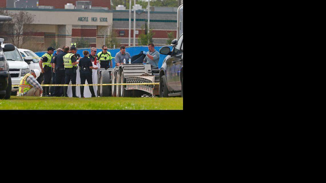
Authorities work to remove the body of a person killed near Argyle High School in Argyle.
