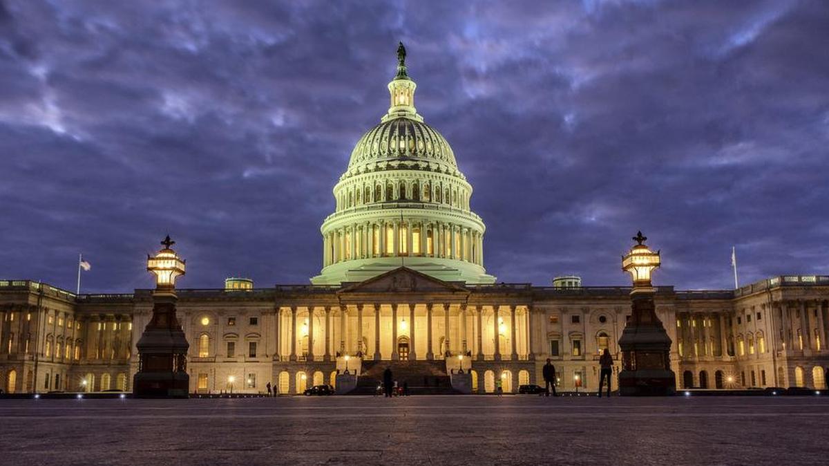 The U.S. Capitol Building shines as night falls in Washington while Congress negotiated the federal government shutdown.