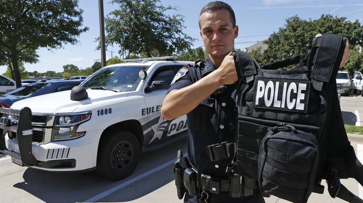 Euless Senior Officer B. Lord with a new armored vest kit in August. The Hurst Police Department is buying similar kits for its officers.