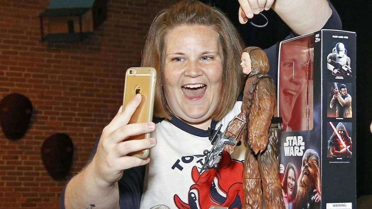 Candace Payne, better known as Chewbacca Mom, streams a Facebook video with her custom Chewbacca Mom action figure during a meet-and-greet at Hasbro headquarters in Pawtucket, R.I.