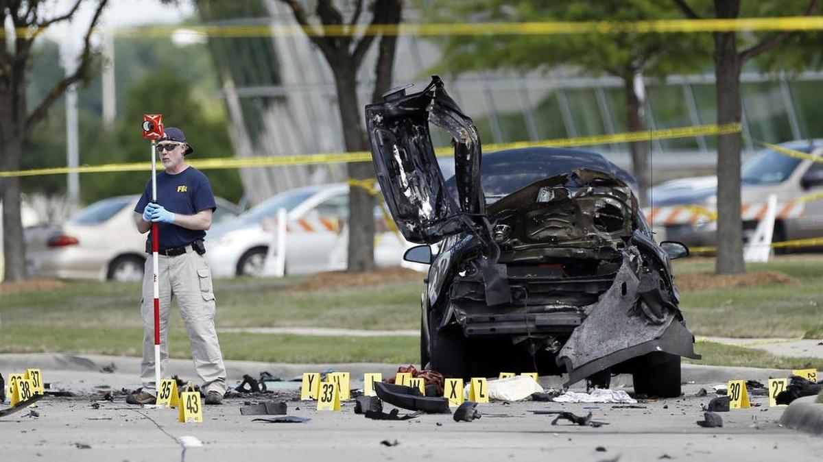 FBI crime scene investigators document evidence outside the Curtis Culwell Center May 4, 2015, in Garland.