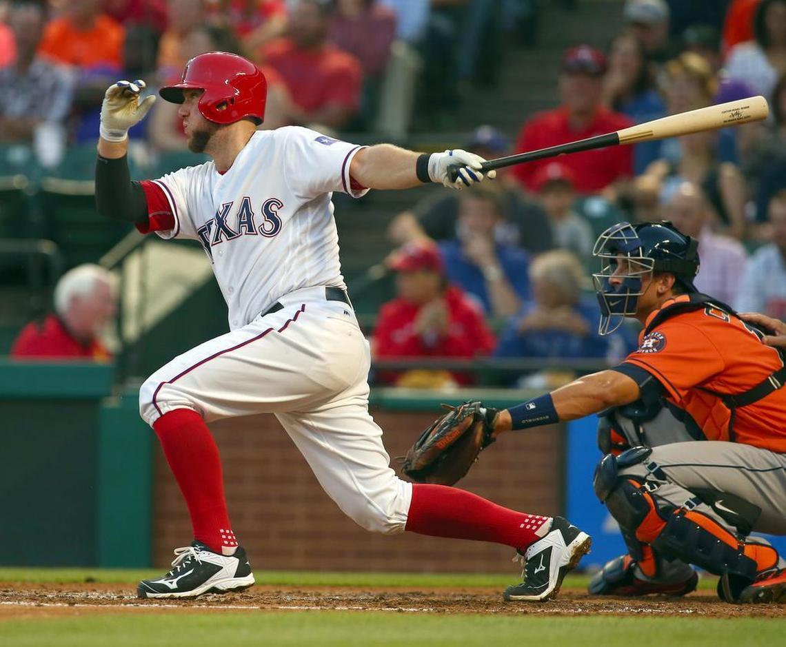 Texas Rangers catcher Bryan Holaday hits a single against the Houston Astros in the second inning April 21, 2016, in Arlington.