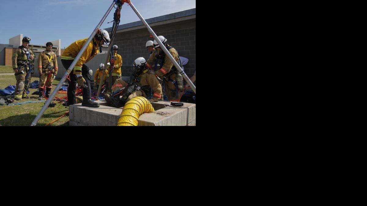 
Fort Worth firefighter Felix Esparza is helped out of a tunnel during a practice drill that simulated the aftermath of a tornado at the Tarrant County College Fire Training Center on Tuesday.
