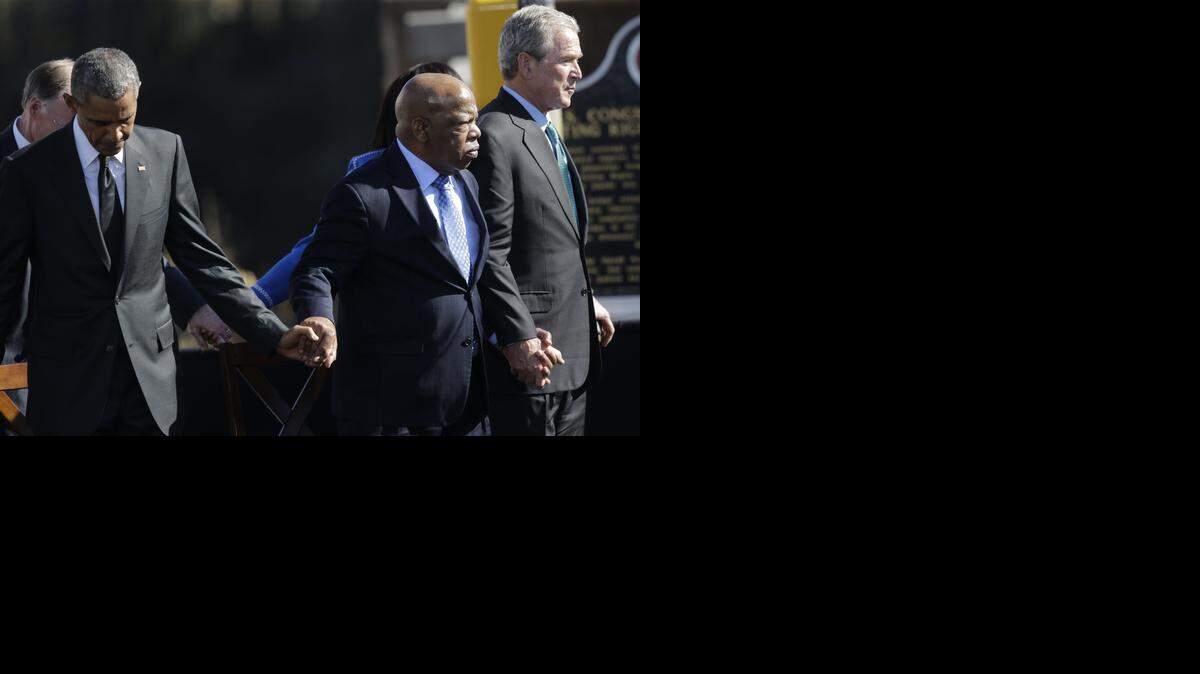 
President Barack Obama, Rep. John Lewis, D-Ga., and former President George W. Bush hold hands for a prayer after Obama’s speech.


