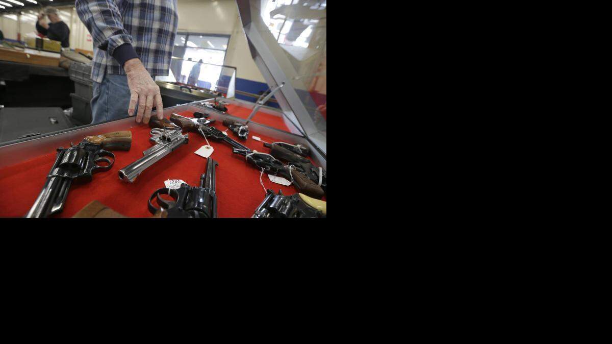 
A dealer arranges handguns in a display case in advance of a show at the Arkansas State Fairgrounds in Little Rock, Ark. A major U.S. trend survey finds that the number of Americans who live in a household with at least one gun is lower than it's ever been. Data from the FBI’s National Instant Criminal Background Check system shows that in recent years there’s actually been an increase in the number of background checks being run, suggesting the total number of firearms being purchased is going up.
