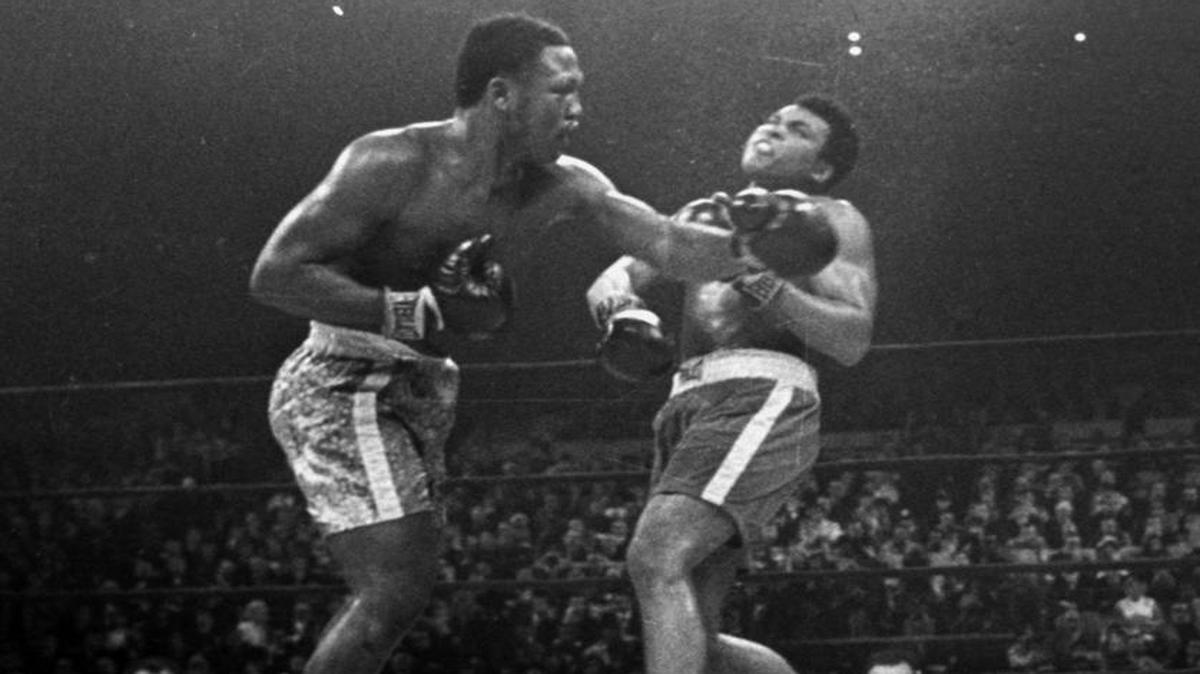In this March 8, 1971, file photo, boxer Joe Frazier, left, knocks downs Muhammad Ali during the 15th round of their heavyweight title fight at New York's Madison Square Garden.