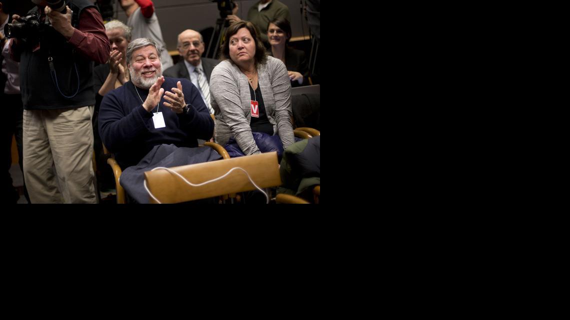 
Co-founded Apple Computers with Steve Wozniak, center, and his wife Janet Hill, right, joins members of the audience in applauding at an open hearing at the Federal Communications Commission in Washington, Thursday, Feb. 26. The FCC has agreed to impose strict new regulations on Internet service providers like Comcast, Verizon and AT&T. The regulatory agency voted 3-2 Thursday in favor of rules aimed at enforcing what's called "net neutrality." That's the idea that service providers shouldn't intentionally block or slow web traffic, creating paid fast lanes on the Internet. (AP Photo/Pablo Martinez Monsivais)
