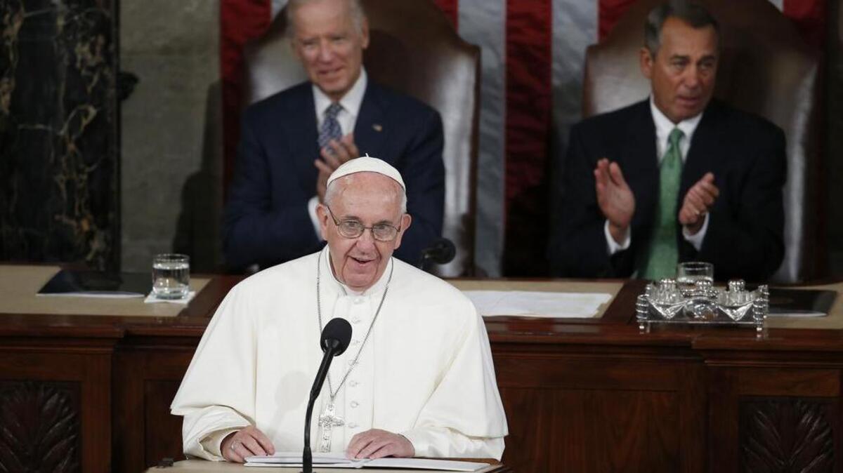 
Pope Francis addresses a joint meeting of Congress on Capitol Hill in Washington, Thursday, Sept. 24, 2015, making history as the first pontiff to do so. Listening behind the pope are Vice President Joe Biden and House Speaker John Boehner of Ohio. 
