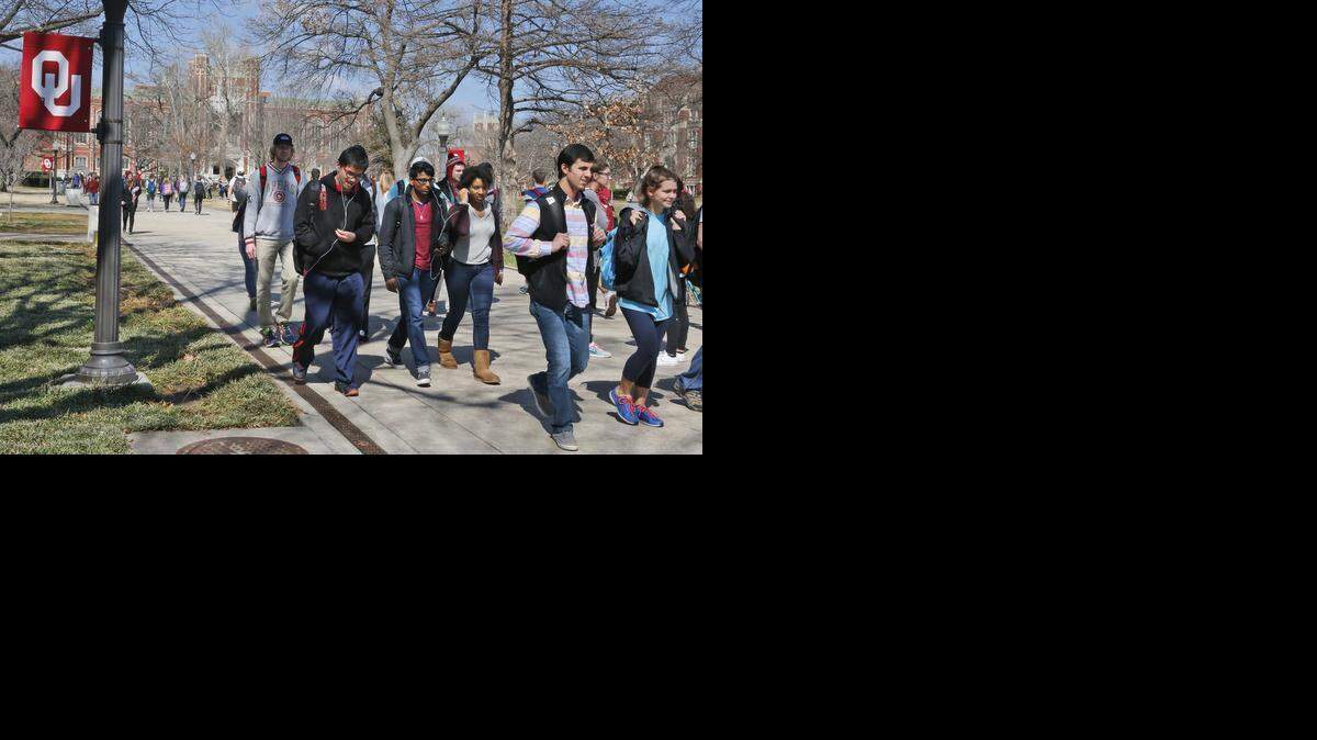 
People walk on the Oval at the University of Oklahoma in Norman, Okla., Tuesday, March 10, 2015. Two students have been expelled from the university after an incident in which members of a fraternity were caught on video chanting a racial slur. 

