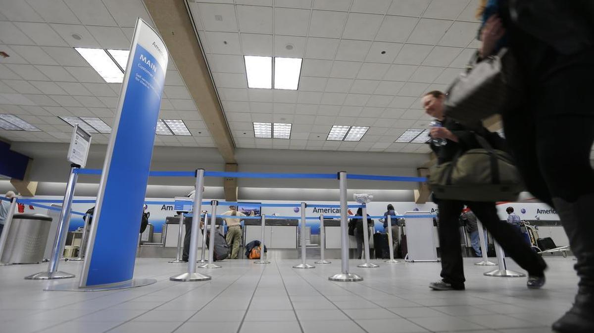 Travelers walk through the American Airlines check in area in a file photo.