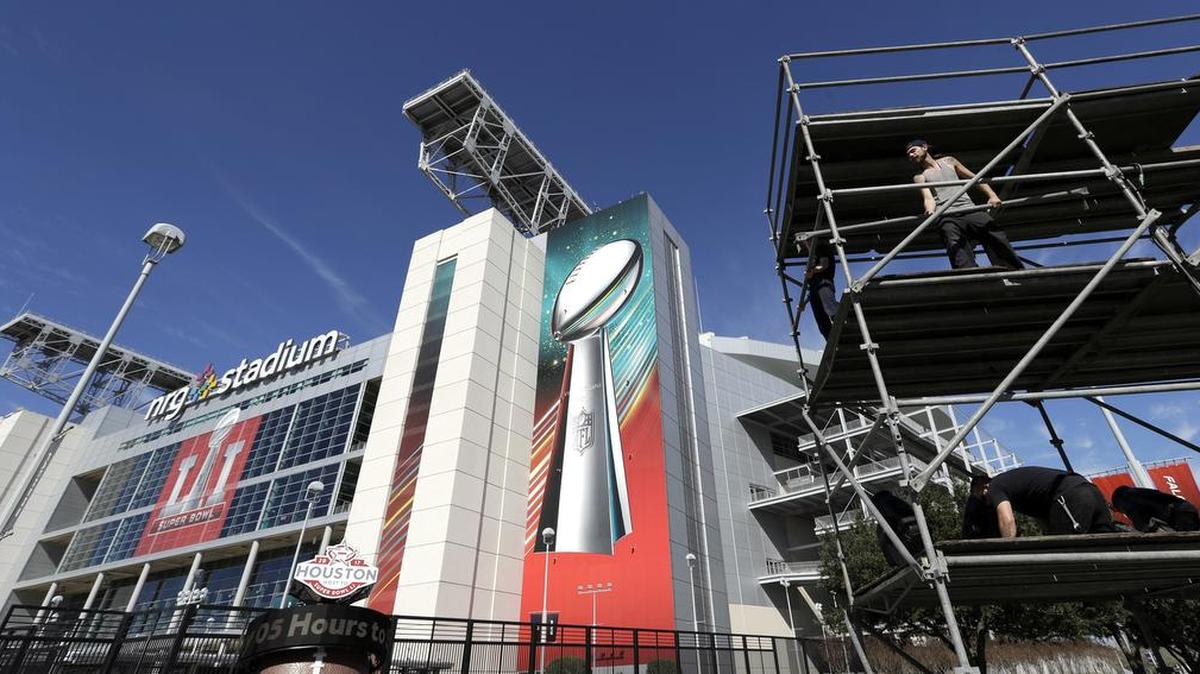 Workers prepare a lighting tower outside NRG Stadium Tuesday in Houston. The New England Patriots will play the Atlanta Falcons in NFL football's Super Bowl LI on Feb. 5 at NRG Stadium.