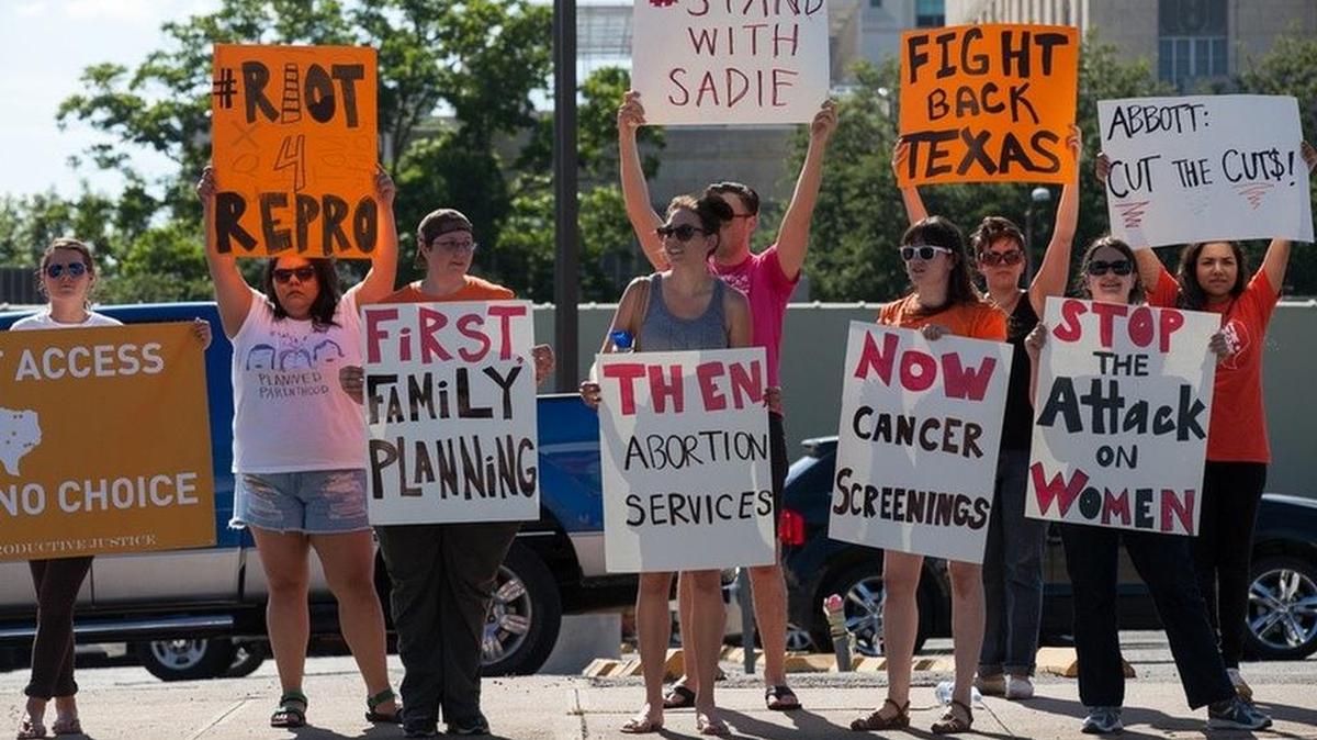 Abortion rights activists protest across from the governor’s mansion in Austin on June 9, 2015.