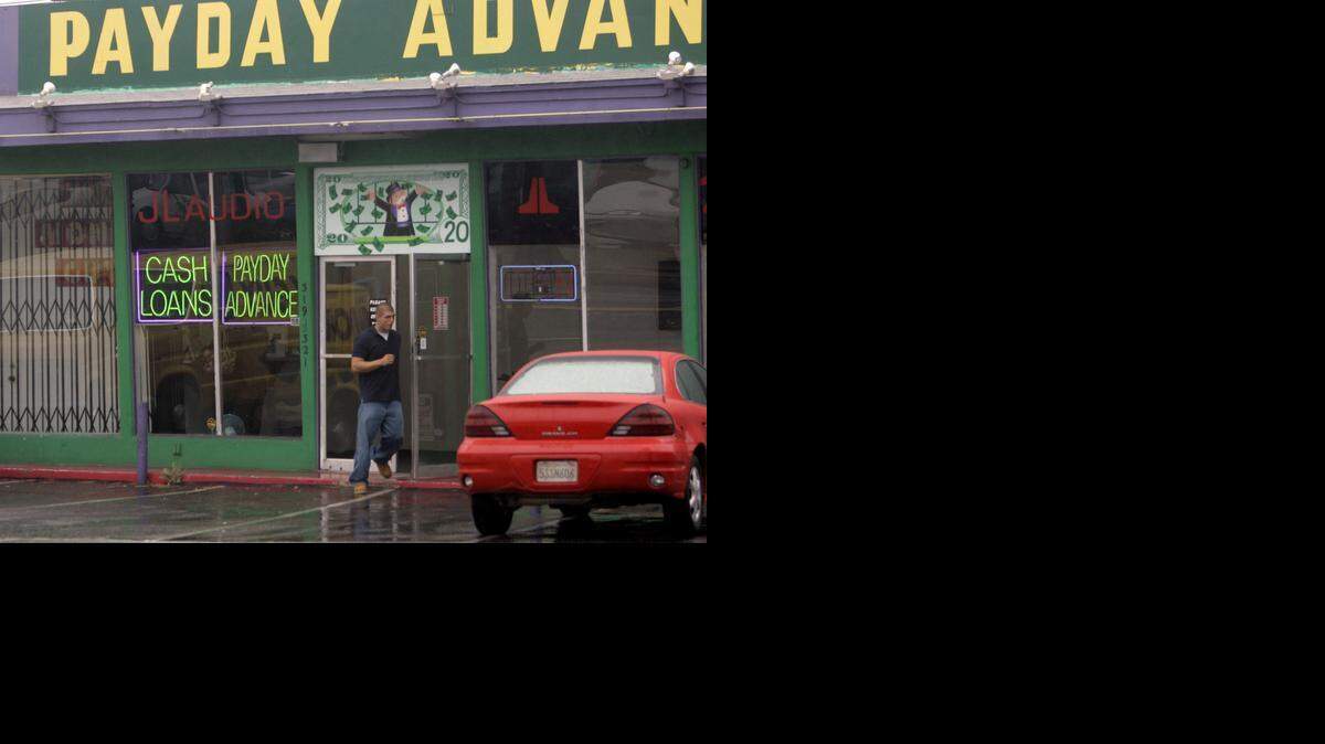 
A customer leaves the Payday Advance store in Oceanside, Calif., Thursday, Aug. 3, 2006. Many of these payday advance lenders charge extremely high interest rates, the kind of fee spurring military brass to lobby for state and federal controls on what they consider predatory lending. The Defense Department is backing an effort in Congress to establish a nationwide cap of 36 percent on loans to troops, while states are increasingly taking steps. (AP Photo/Lenny Ignelzi) ORG XMIT: CALI201

