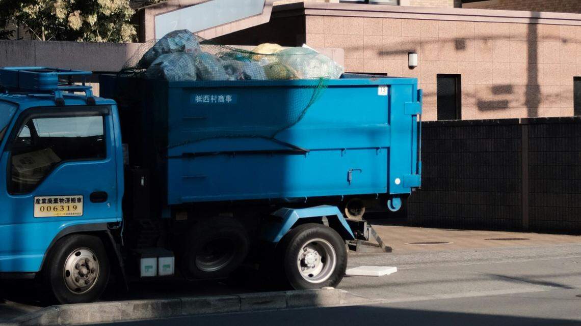 The 3-day-old baby was discovered in the bottom of a garbage truck (not the one pictured), investigators said.