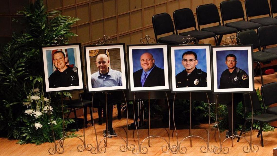 The stage at the Meyerson is graced with the portraits of the fallen officers, from left: Michael Krol, Brent Thompson, Lorne Ahrens, Michael Smith and Patrick Zamarripa.