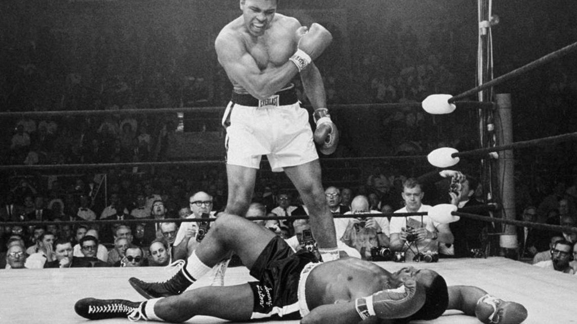 FILE: In this May 25, 1965, file photo, heavyweight champion Muhammad Ali, then known as Cassius Clay, stands over challenger Sonny Liston, shouting and gesturing shortly after dropping Liston with a short hard right to the jaw, in Lewiston, Maine. Ali, the magnificent heavyweight champion whose fast fists and irrepressible personality transcended sports and captivated the world, has died according to a statement released by his family Friday, June 3, 2016. He was 74. (AP Photo/John Rooney, File)