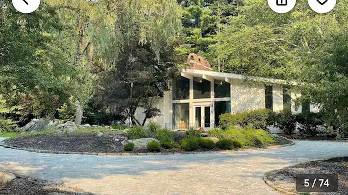 The home is at the end of a long, gated driveway.