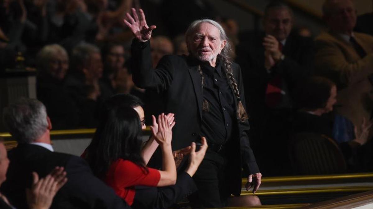 Willie Nelson waves to the crowd at the start of a show honoring him with the 2015 Library of Congress Gershwin Prize for Popular Song on Wednesday, Nov. 18, 2015 in Washington.