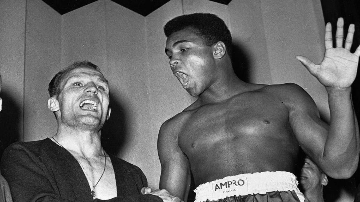 Before he became Muhammad Ali, the boxer was known as Cassius Clay, as shown here in 1963 in a pre-fight publicity stunt with British heavyweight champion Henry Cooper, who would lose twice to Ali.