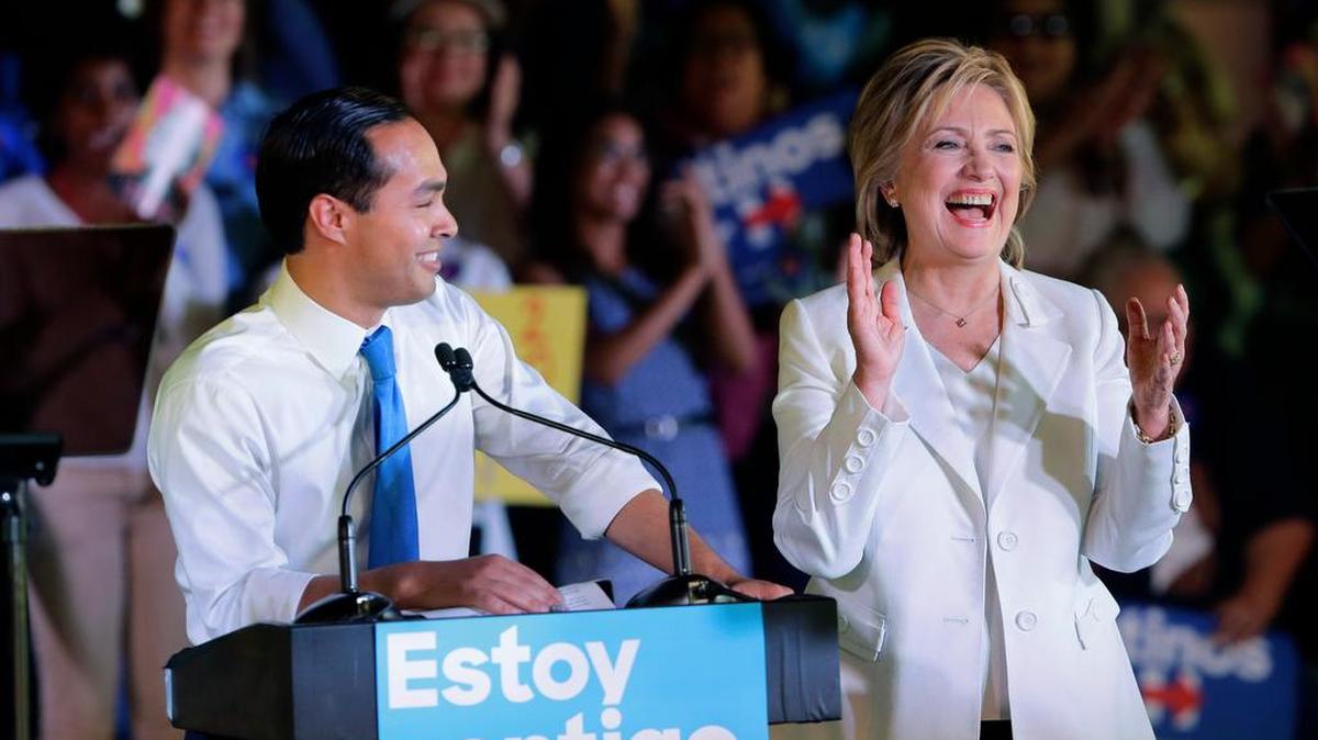
Democratic presidential candidate Hillary Rodham Clinton joins Housing and Urban Development Secretary Julian Castro on the stage during a campaign event Thursday in San Antonio.

