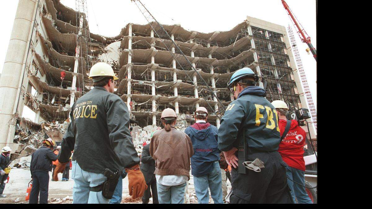 
Police and federal agents stand guard after a bomb blast destroyed the Alfred P. Murrah Federal Building in Oklahoma City. 
