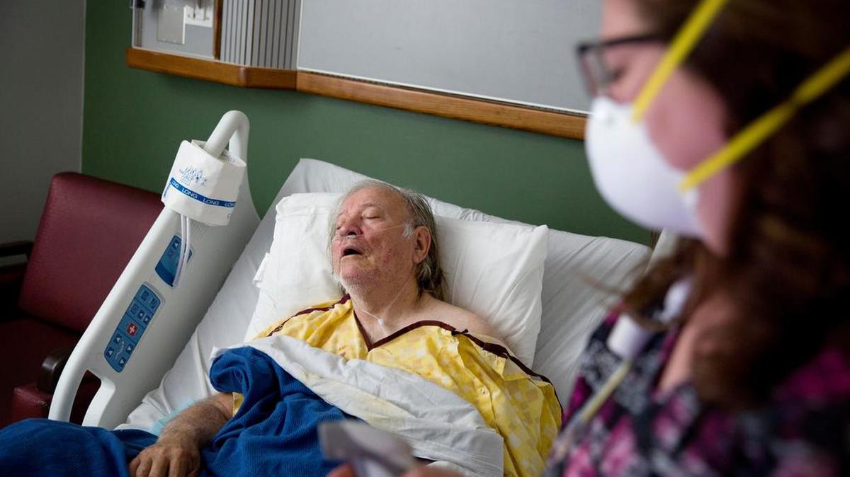 Henry Beverly, 73, battles the flu while tended to by nurse Kathleen Burks at Upson Regional Medical Center in Thomaston, Ga., on Friday, Feb. 9. The flu has further tightened its grip on the U.S., and this season is now as bad as the swine flu epidemic nine years ago.