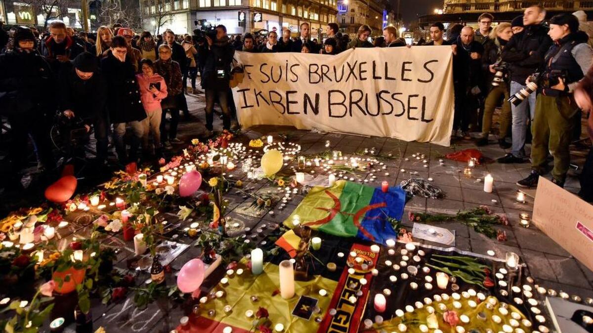 People mourning those who died hold a banner proclaiming “I am Brussels” at the Place de la Bourse in the center of Brussels on Tuesday.